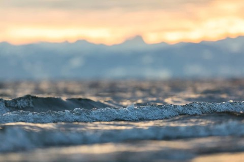 Sunrise on a wintry lake in bad weather