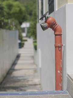 Red fire hydrant water pipe near the road