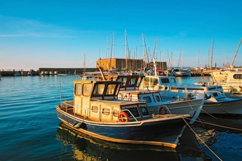 Venetian Fort Venetian fortress of Koules Castello a Mare castle in Heraklion and moored Greek fishing boats in port