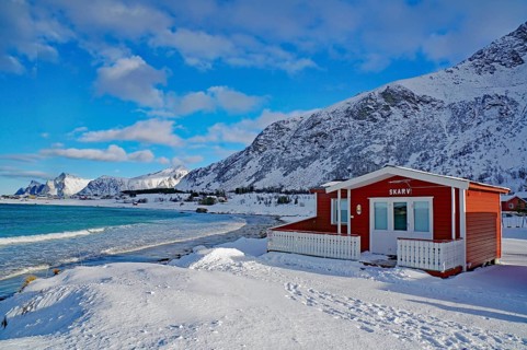 Red cottage in winter landscape
