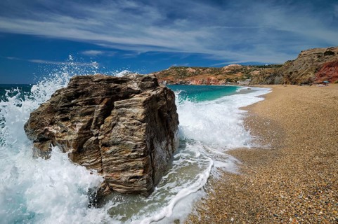 Rocks on Paleochori beach and waves of Aegean sea