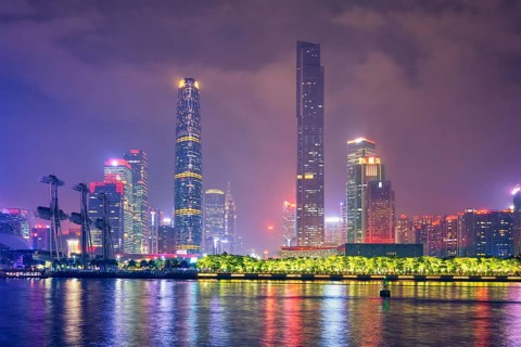 Guangzhou cityscape skyline over the Pearl River illuminated in the evening. Guangzhou