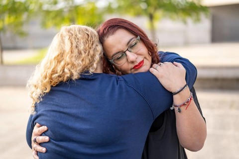 Couple of lesbian women hugging in a park