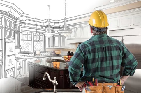 Male contractor with hard hat and tool belt looking at custom kitchen drawing photo combination on white