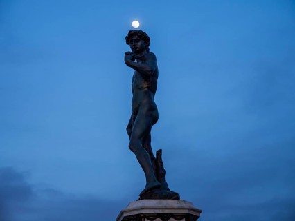 Full moon over the statue of David in Piazzale Michelangelo