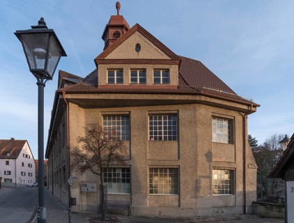 Historic main building of a former valve factory in the evening light