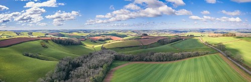 Panorama over Fields and Meadows over English Village
