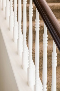 Stair railing and steps with carpet in house