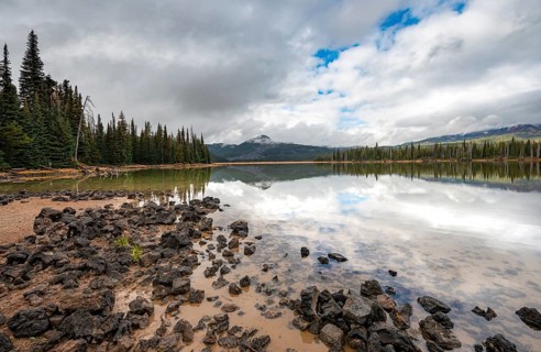 Black stones on the lake shore