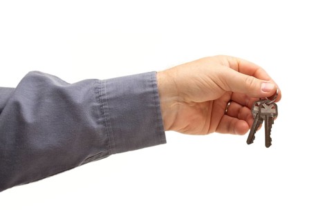 Man handing over the keys isolated on a white background