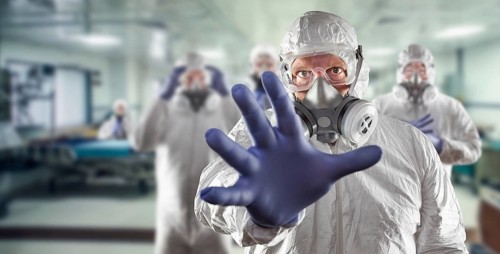 Team of female and male doctors or nurses wearing personal protective equipment in hospital emergency room