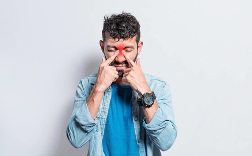 People with pain touching nose. Handsome man with nasal bridge pain