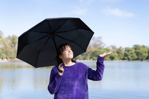 Latin woman with umbrella on a sunny day