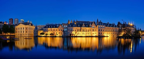 Panorama of the Binnenhof House of Parliament and Mauritshuis museum and the Hofvijver lake illuminated in the night. The Hague