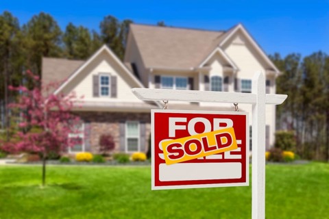 Sold home for sale real estate sign and beautiful new house