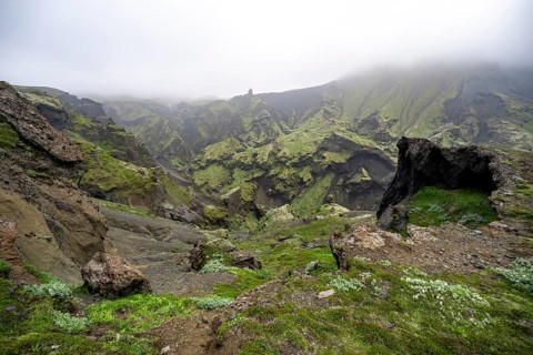 View into rugged moss-covered canyon with tufa rock formations