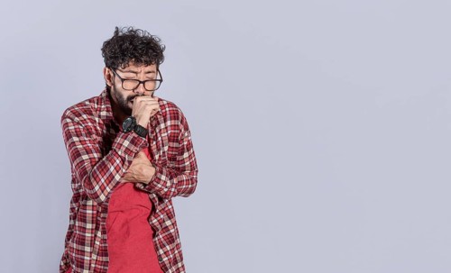 Young man coughing a lot