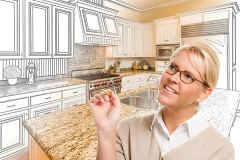 Creative woman with pencil over custom kitchen design drawing and photo combination