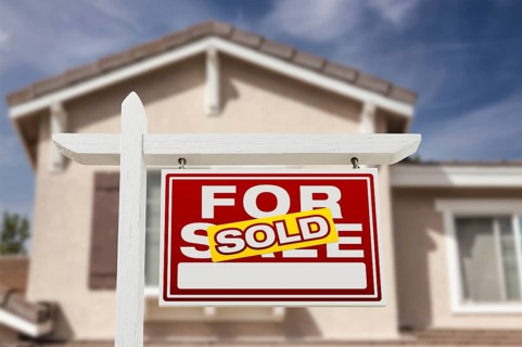 Sold home for sale real estate sign and house