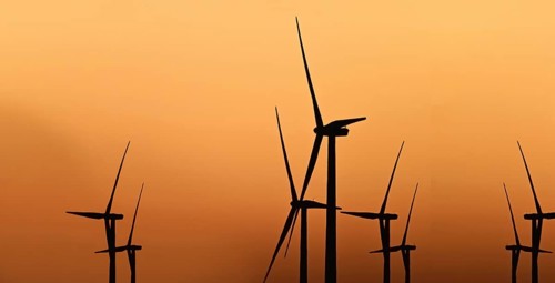 Windmill at sunset against light