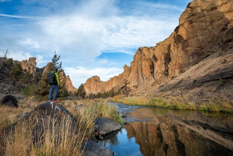 Young man standing on stone on the shore