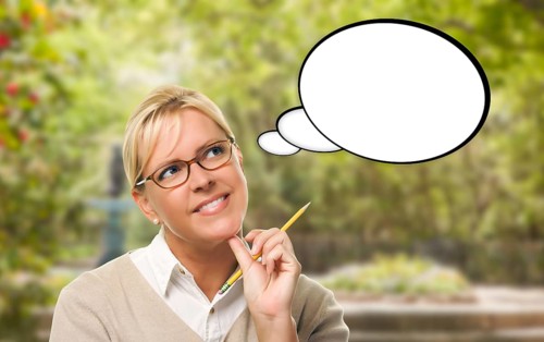 Thoughtful young woman with pencil and blank thought bubble