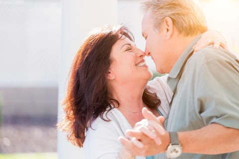 Happy middle aged couple enjoy A romantic slow dance outside