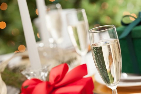 Champagne glass and christmas gift with place setting abstract at table