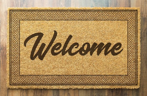 Welcome mat on A wood floor background