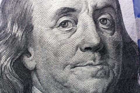 Close up of Benjamin Franklin face on 100 US dollar bill