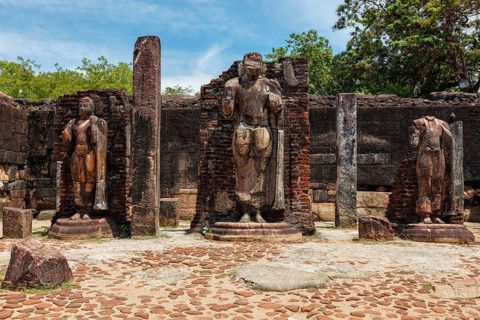 Standing Buddha statue in ancient ruins