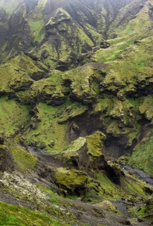 View into rugged moss-covered canyon with tufa rock formations