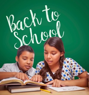 Back to school written on chalk board behind hispanic boy and girl having fun studying together