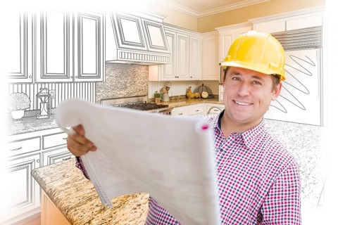 Smiling contractor holding blueprints over custom kitchen drawing and photo combination