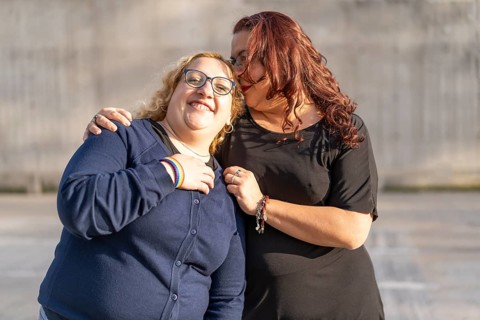 Couple of lesbian women hugging in a park