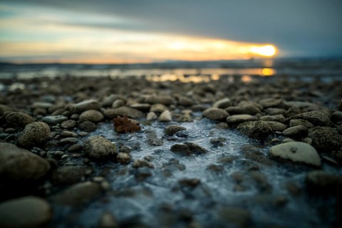 Sunrise on a wintry lake in bad weather