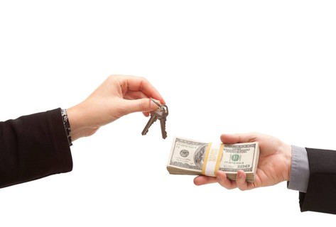 Handing over cash for keys isolated on a white background