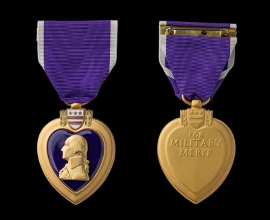 Front and back of purple heart military merit medal against black background