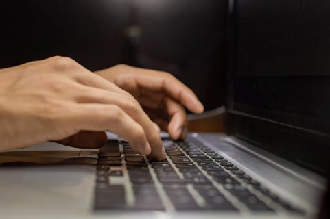 Hands on laptop keyboard