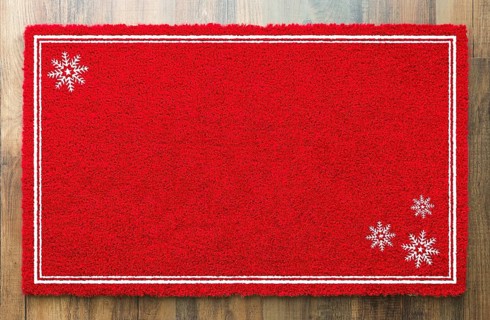 Blank holiday red welcome mat with snow flakes on wood floor background