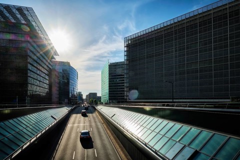 Street traffic in Brussels near European Commission building on sunset. Rue de la Loi