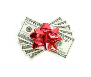 Stack of money with bow isolated on a white background