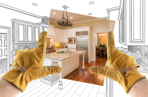 Male contractor hands framing completed section of custom kitchen design drawing