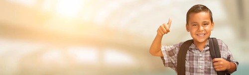 Young hispanic male child showing thumbs up wearing backpack with room for text