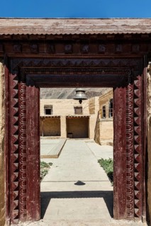 Gates with bell of Tabo monastery of Tibetan Buddhist Gelug sect. Monastery is built on high Himalaya plato in tradition of Tibetan Buddhism. Tabo village