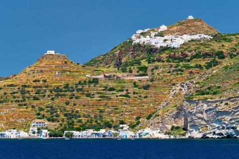 Klima and Plaka villages with whitewhashed traditional houses and orthodox church and windmills on Milos island