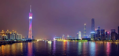 Guangzhou cityscape skyline ver the Pearl River illuminated in the evening panorama