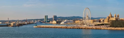 Panorama of Grande Roue de Marseille Ferris wheel and Marseille cathedral and port of Marseille on sunset