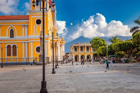 Beautiful plaza with people around in a sunset