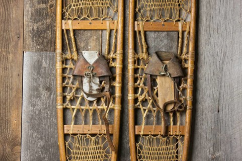 Antique snowshoes on rustic cabin wall
